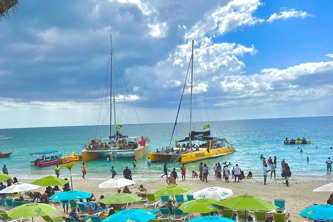 7 Mile Beach Party Catamaran Cruise with Snorkeling & Ricks Cafe - Key points at a glance