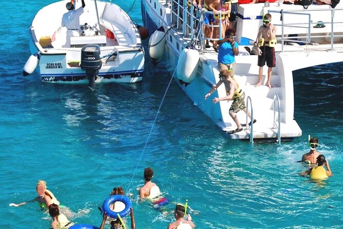 Catamaran Party Cruise and Snorkeling from Montego Bay - The onboard party: music, snacks, and an open bar