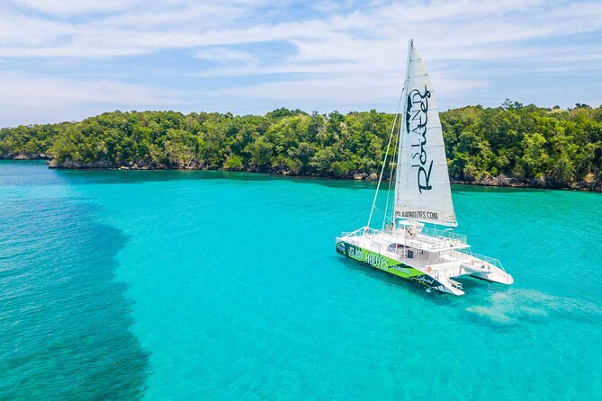 A catamaran anchored over turquoise water off the Montego Bay coast